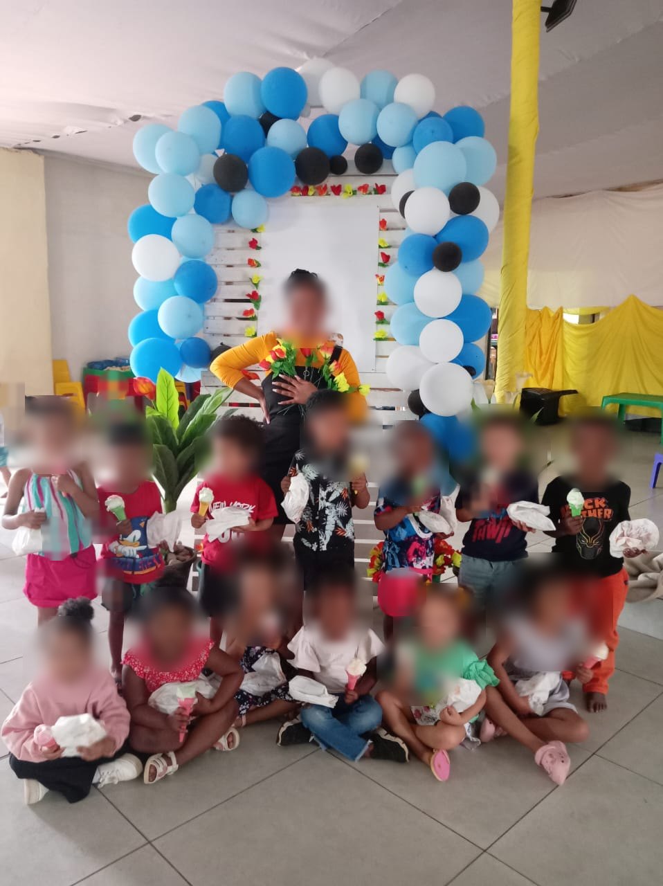 Children at a celebration day at Little Wonder. Children's faces are blurred.