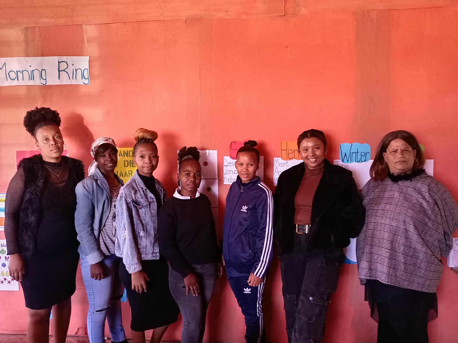 The Little Wonder team standing together in a classroom